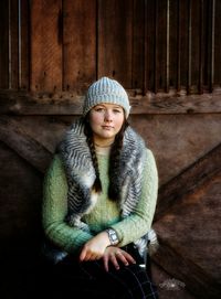 Portrait of girl wearing knit hat standing at home