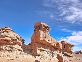 Low angle view of rock formation against sky