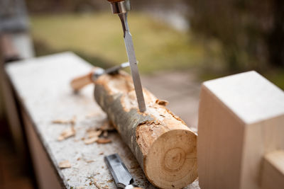 Close-up of tools on log