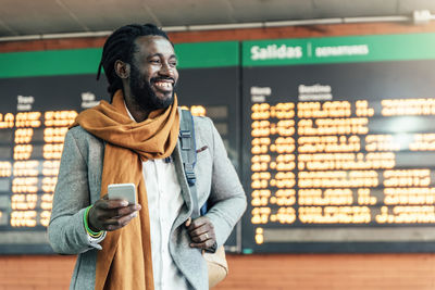 Businessman using phone at airport