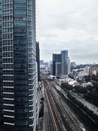 High angle view of railroad tracks amidst buildings in city