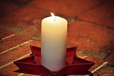 Close-up of illuminated candles on table