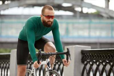 Side view of man riding bicycle