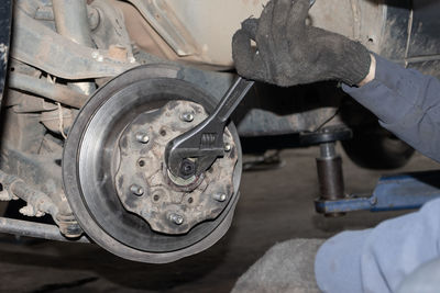 Cropped image of man repairing car