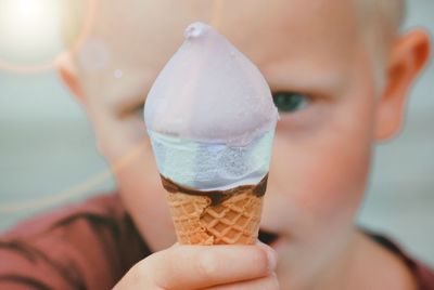 Close-up of hand holding ice cream cone