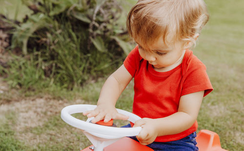 Cute baby girl playing at back yard