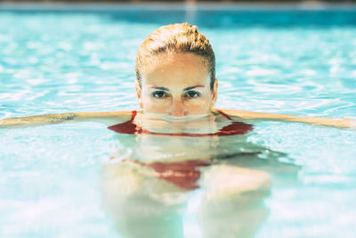 Portrait of woman swimming in pool