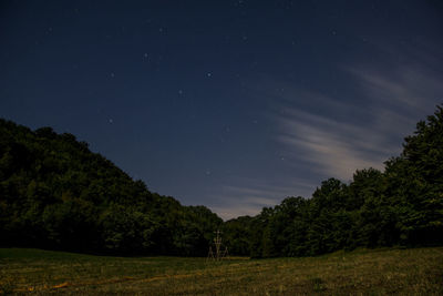 Scenic view of trees against sky at night