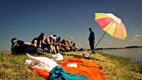 Firefighter by lake on sunny day