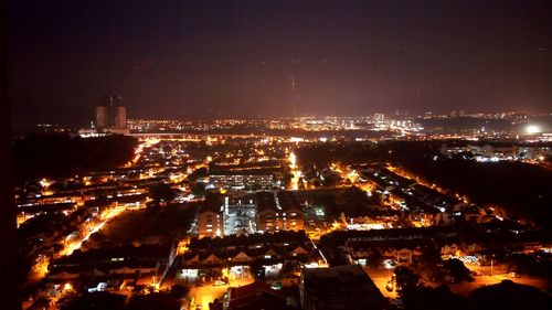 High angle view of illuminated buildings in city at night
