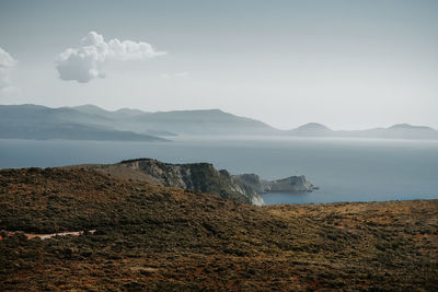 Scenic view of sea and mountains against sky