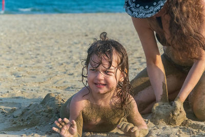 Rear view of father and girl on beach