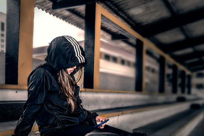 Side view of woman sitting in bus