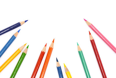 Close-up of colored pencils against white background