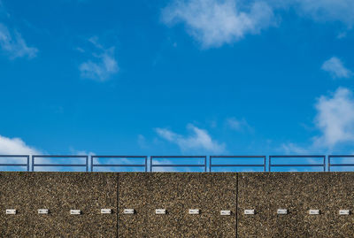 Low angle view of concrete fence against sky