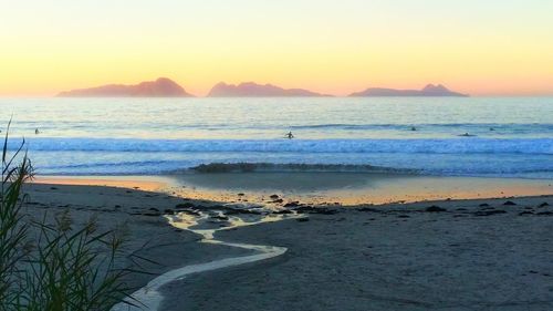 Scenic view of beach against sky during sunset