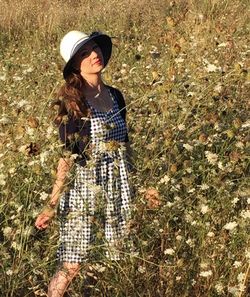 Young woman standing on grassy field