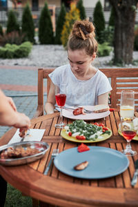 Girl sitting at restaurant outdoors