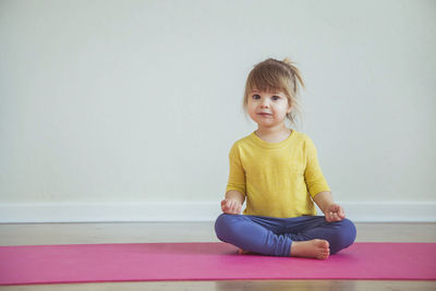 Adorable baby doing yoga