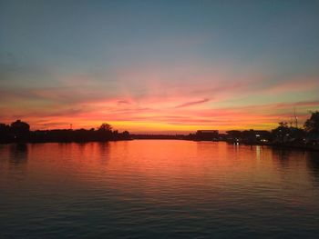 Scenic view of lake against romantic sky at sunset