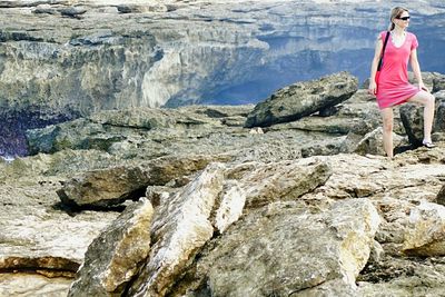 Woman standing on rock formation