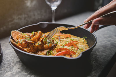 Tourist enjoying peruvian food rice with seafood. arroz con mariscos, food served in pan