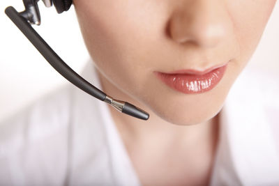 Business woman with headset in a white shirt