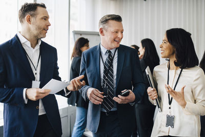 Smiling business people discussing in office seminar