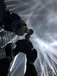 Low section of men standing against sky