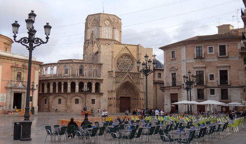 Group of people in front of historic building in city