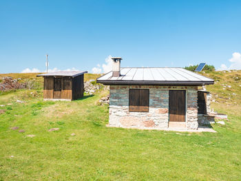 Stony holiday cottage hidden in meadow at peak of canfedin mountain. vezzano region, trentino, italy