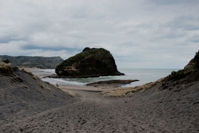 View of beach against cloudy sky