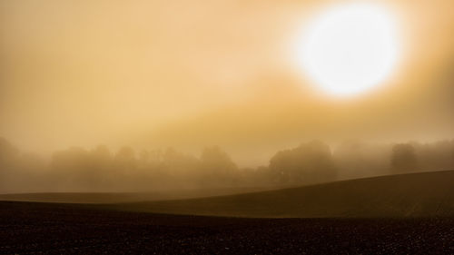 Scenic view of field against sky during sunset