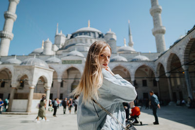 Girl in the blue mosque in istanbul, turkey. high quality photo