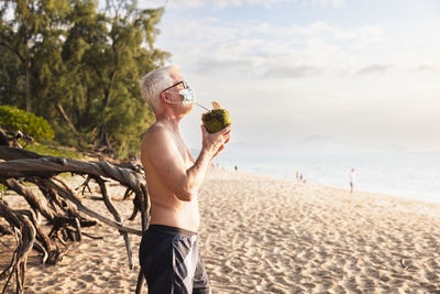 Man on beach wearing face mask