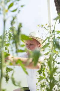 Man standing by flowering plants