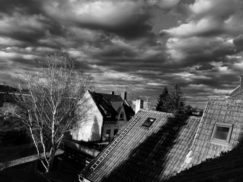 Buildings in city against cloudy sky