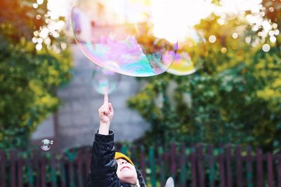 Girl playing with bubble in yard