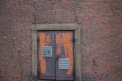 Closed door on brick wall