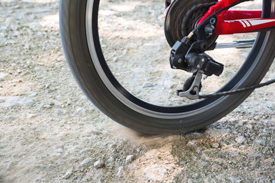 Bicycle wheel in motion close-up. land with under the wheels