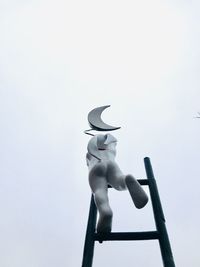 Low angle view of sculpture against sky