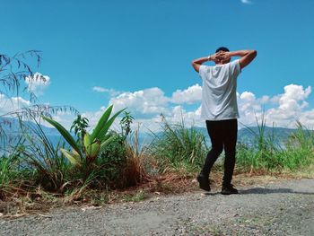 Full length of man standing on field against sky