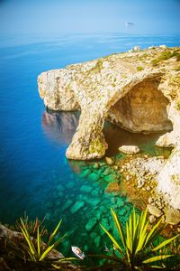 Scenic view of sea against rock formation