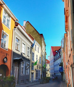 Buildings in city against blue sky