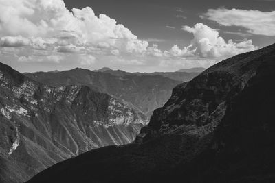 Scenic view of mountains against cloudy sky