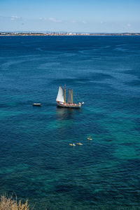 Sailboat sailing in sea against sky