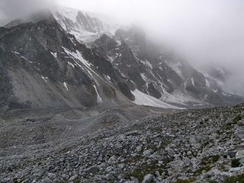 Scenic view of mountains against cloudy sky