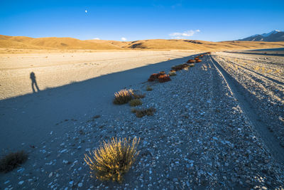 Scenic view of desert land against sky