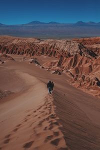 High angle view of people walking on sand