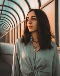 Portrait of beautiful young woman looking away